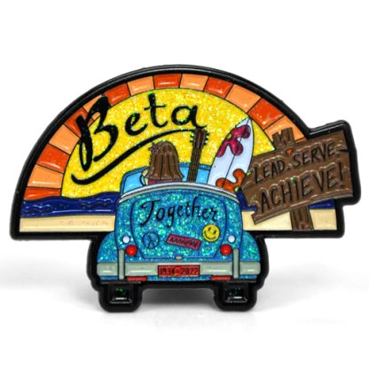 Custom glitter Beta pin of a surfboard-topped car under a sunrise with a Lead, Serve, Achieve sign
