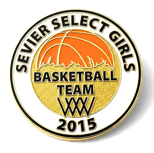Round custom trading pin for the Sevier Select Girls Basketball Team, featuring a bold orange basketball over a gold glitter background with stylized flames. Text around the pin reads “Sevier Select Girls Basketball Team XXXV 2015.