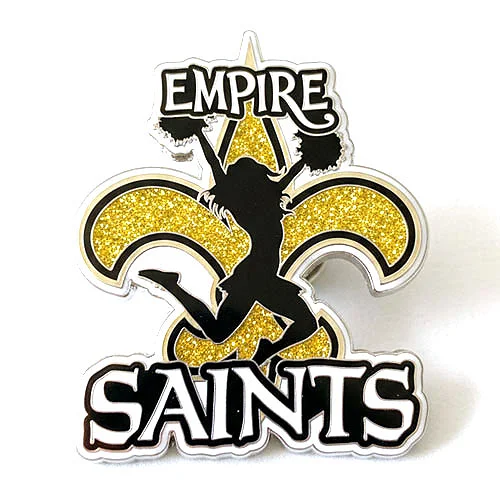 Custom trading pin featuring a black silhouette of a cheerleader jumping in front of a gold glitter fleur-de-lis. The top of the pin reads “Empire” and the bottom says “Saints” in bold white and black lettering.