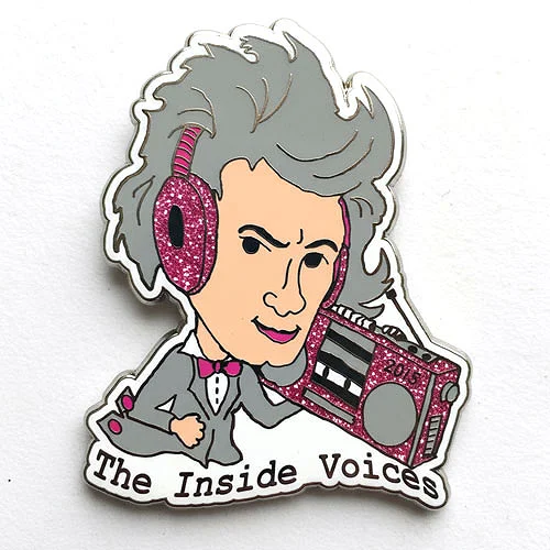 Custom trading pin featuring a cartoon character with wild gray hair wearing glittery pink headphones and holding a matching pink boombox labeled “2019.” The character is dressed in a tuxedo with the words “The Inside Voices” below.