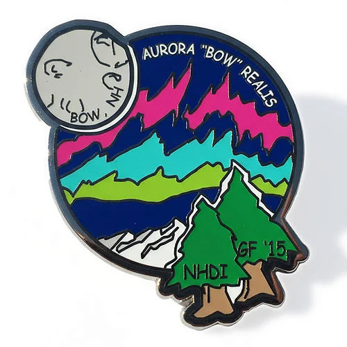 Aurora “Bow” Realis custom trading pin with northern lights and moon face design. Custom trading pin featuring a colorful aurora borealis sky in shades of pink, teal, and green above mountain peaks and pine trees labeled “NHDI” and “GF '15.” A full moon in the upper left corner has a face with the words “PHI” and “BOW,” and the pin reads “Aurora ‘Bow’ Realis.”
