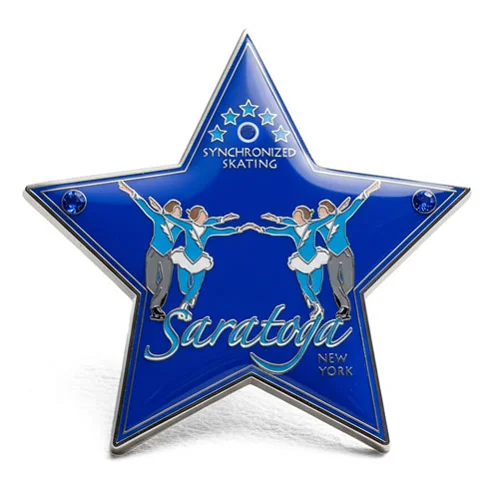 Star-shaped custom trading pin for Saratoga Synchronized Skating, featuring three pairs of skaters in matching blue and white outfits performing a routine. The deep blue background includes the text “Saratoga New York” and “Synchronized Skating” with stars and gem accents.