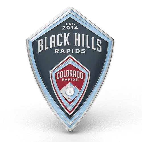 Custom shield-shaped trading pin for Black Hills Rapids soccer club, est. 2014, in dark gray and light blue with a red Colorado Rapids crest and soccer ball in the center.