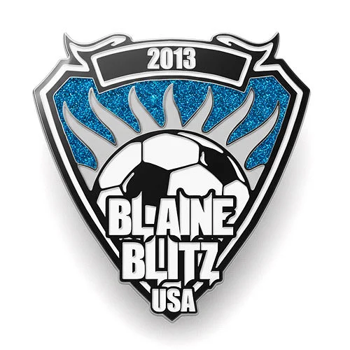 Shield-shaped custom trading pin for the Black Hills Rapids soccer team, featuring a clean blue and gray design with “Est. 2014” at the top. A smaller red and white Colorado Rapids logo is centered at the bottom of the shield, representing the club affiliation.